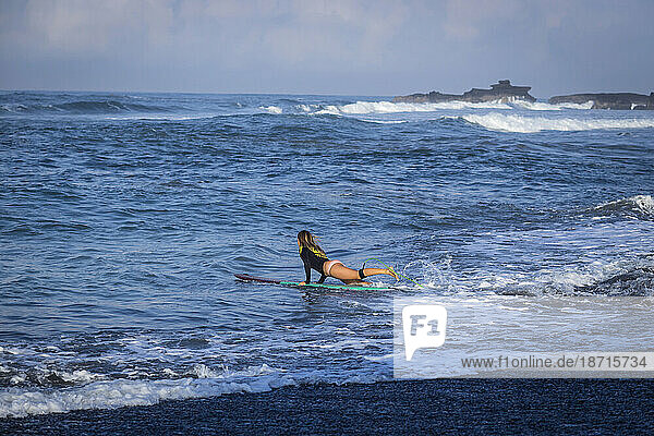 Surfer on beach in Bali  Indonesia.