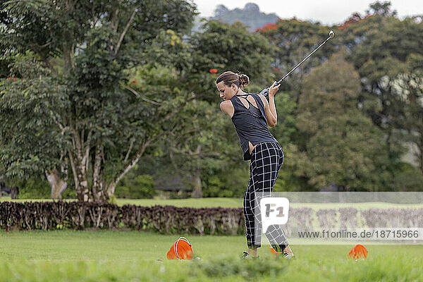 Woman playing golf  Bedugul  Bali  Indonesia