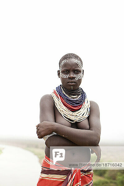 A portrait of a woman dressed in the traditional clothes and decoration in the Omo Valley  Ethiopia.