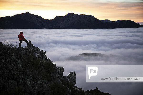 Man Observe Mists at sunrise from the top of some mountains