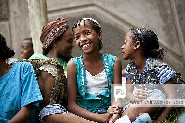 A girl laughs with her new family  13 other HIV positive orphans who live with her  during a Sunday bible study at the Artists For Charity Home  Addis Ababa  Ethiopia.
