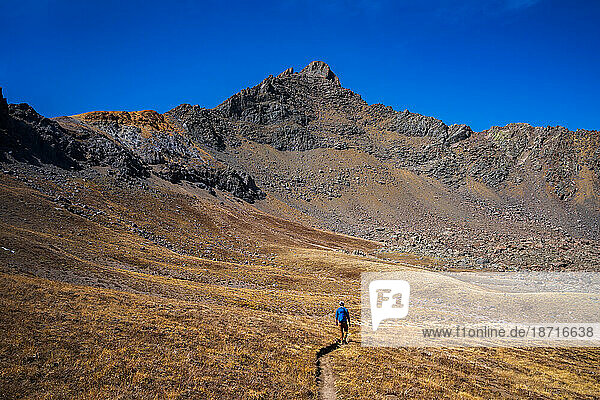 Man Hiking Wetterhorn Peak in the San Juan Mountains of Colorado