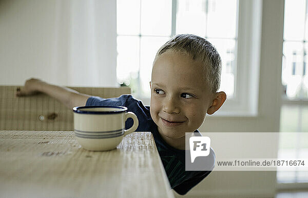 portrait of a young boy looking mischievous at home