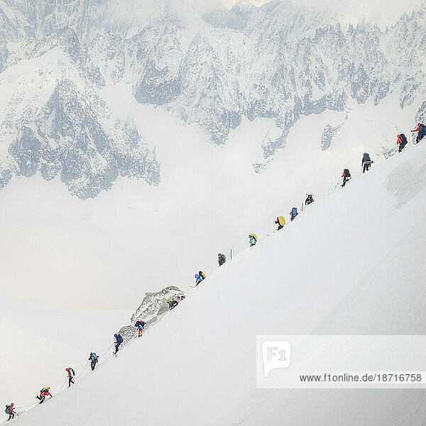 Traffic jam on Mt Blanc as a string of climbers navigate a steep ridge
