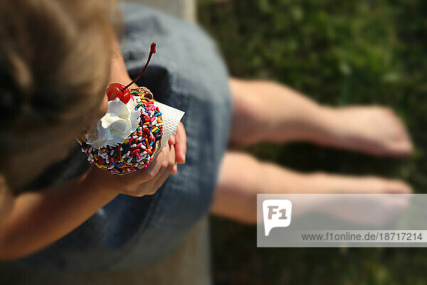 A young girl eats ice cream in New Town  Missouri.