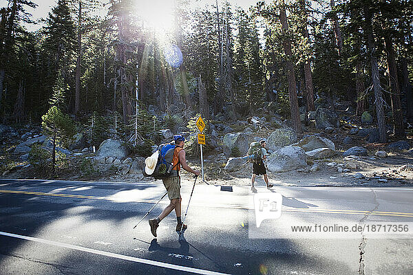 Two hikers cross Highway 50 in Lake Tahoe  CA.