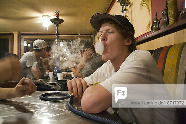 A young man smokes hookah at Zaina in downtown Seattle  Washington.