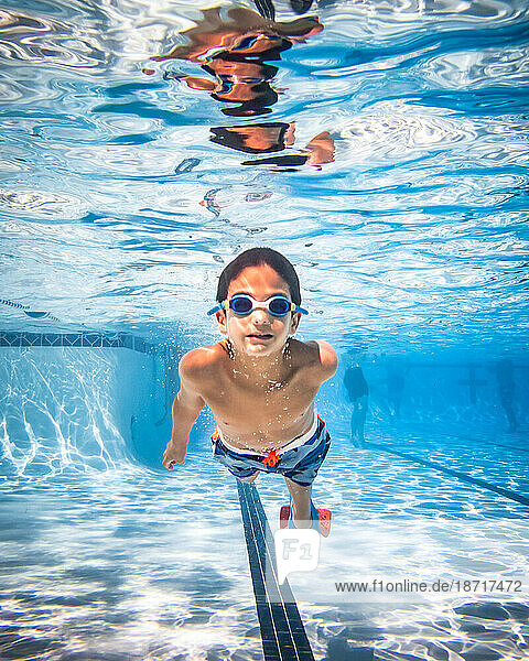Underwater photograph of boy swimming.