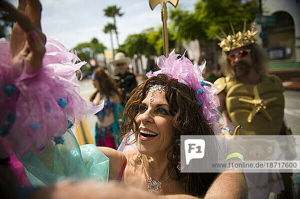 A costumed woman at a summer parade in Santa Barbara. The parade features extravagant floats and costumes.