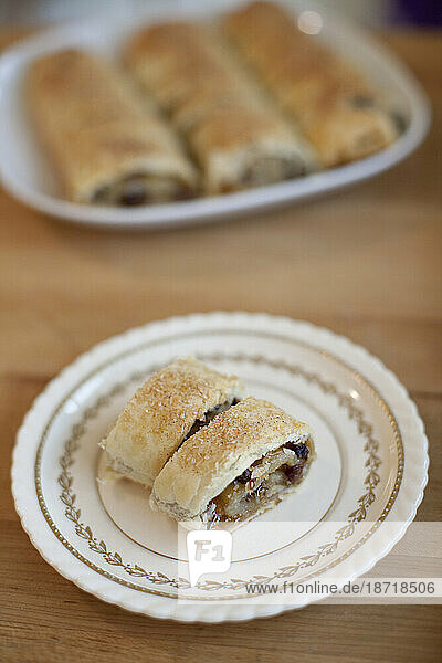 Two pieces of organic homemade Rugelach Jewish cookies rest on a vintage plate in a kitchen in Seattle  Washington.