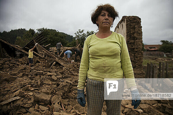 Portrait of a local woman in front of the rubble of a collapsed building  destroyed in the earthquake that struck Chile in Early 2010.