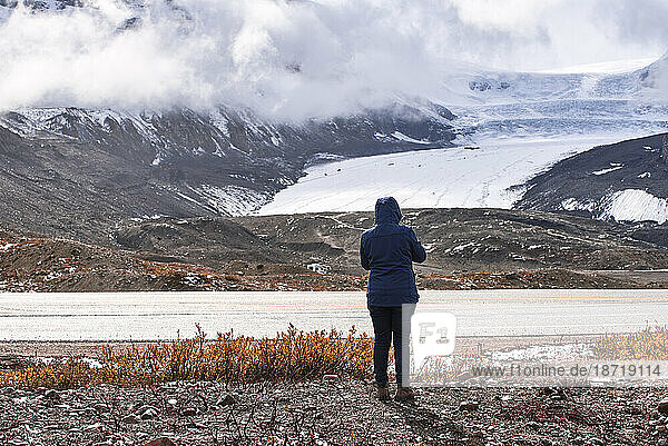 Woman watching Athabasca glacier  Jasper National Park
