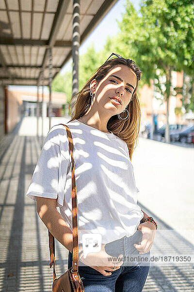 Beautiful smiling girl wearing casual summer clothes enjoys sunny day. Beauty  fashion shot.