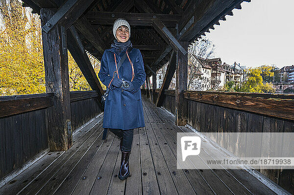 woman walking over wooden bridge in Nuremberg / Germany