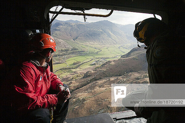 Members of Langdale/Ambleside Mountain Rescue team and an RAF whinch man in an RAF Sea King helicopter during a rescue in Dungeon Ghyll in the Langdale Pikes  UK.