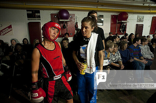 Female coach and boxer stand ringside as they prepare for a fight  Toronto  Newsgirls.