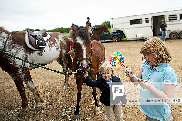 A young equestrian poses with her pony at the Alpine Farms Classic horse show at Alpine Farms in Medina  Minnesota.