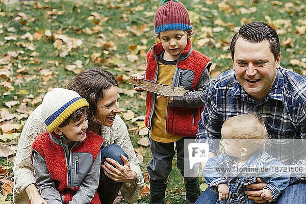 a happy family play together in a grassy lawn