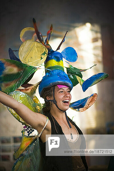 A woman getting ready for a parade in Santa Barbara. The parade features extravagant floats and costumes.