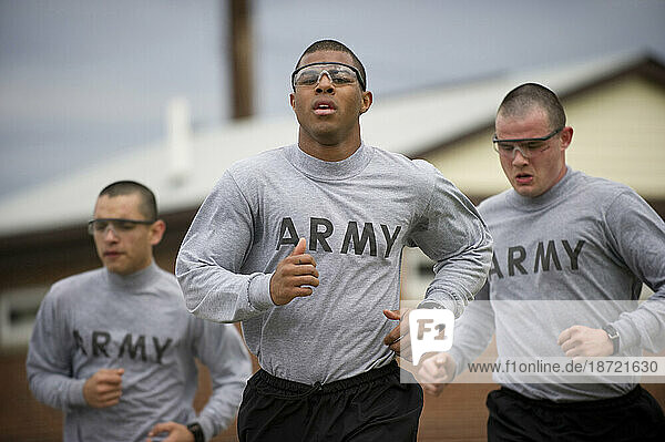 Soldiers in basic training run during physical training.