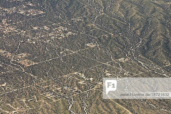 Aerial view of sparse development and unpaved roads in the outskirts of Phoenix  Arizona.