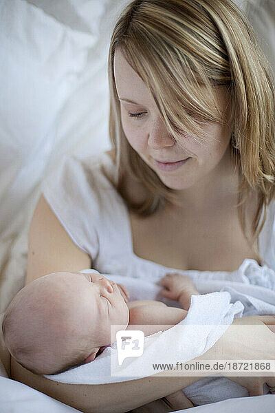Salmon Arm  BC - A young mother holds her one week-old daughter - a baby girl  born March 2010 weighing 8 lb.13oz.