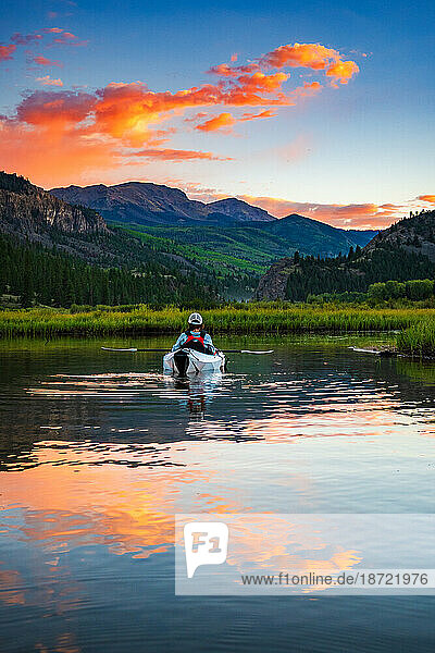 Woman Kayaking at Sunset in the Colorado Mountains