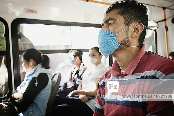 A man inside a bus wearing a mask during the swine flu epidemic in Mexico City  DF  Mexico.