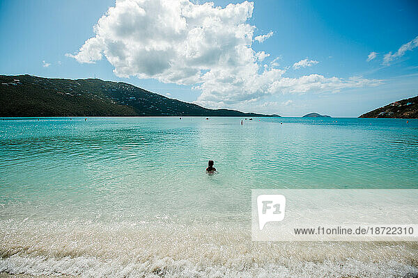 Girl in the calm Caribbean water of Magen's Bay Beach St Thomas USVI