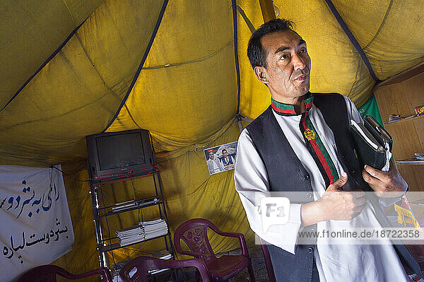 A presidential candidate waits for an interview in his tent that serves as campaign headquarters  in Kabul.