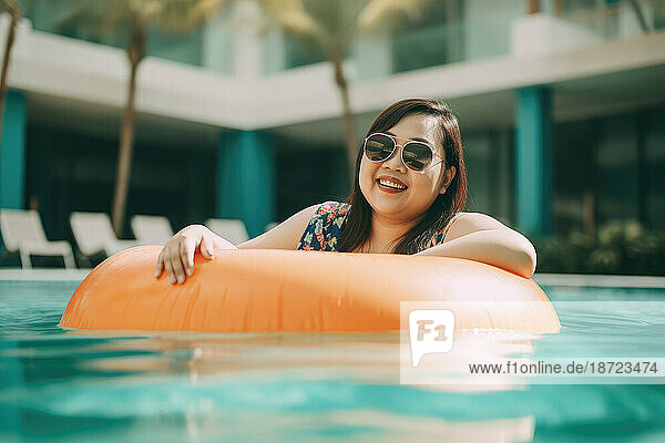 Happy asian plus size woman in a pool with ring float. Generative AI.