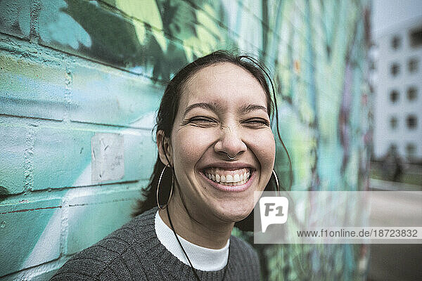Happy mixed race woman with toothy smile.