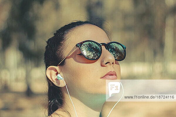 Portrait of a young girl listening music outdoor