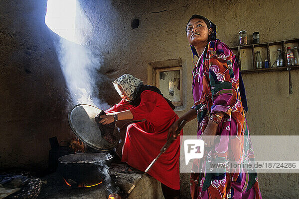 Women cook over an open fire in the kitchen area of a traditional northern Afghan home on the outskirts of Mazar-i Sharif  Afghanistan
