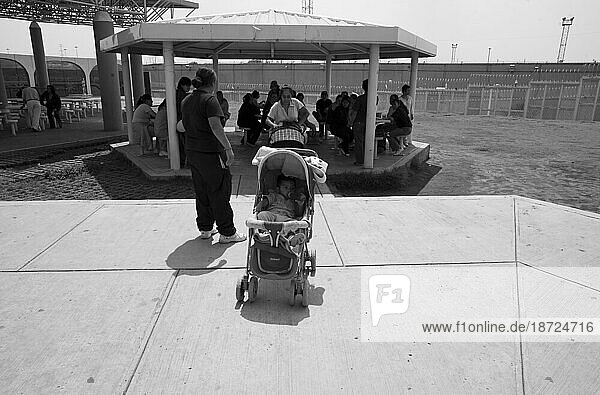 A baby in a stroller in a prison yard in Mexico D.F.