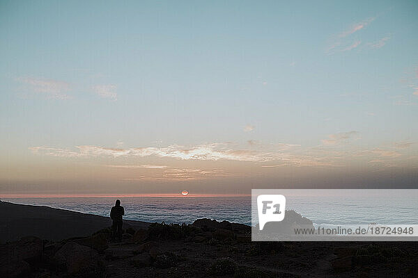 A hiker watching the sunrise in the top of Guajara Mountain  El Teide