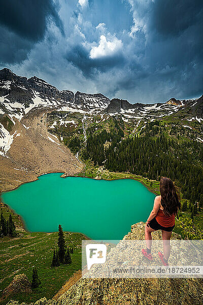Female Hiker overlooking Stormy Blue Lakes in the San Juan Mountains