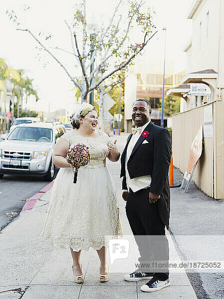 A couple walks the streets of Little Italy in San Diego after their wedding on Dec. 12  2015.