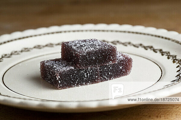 Three pieces of sugared organic pate de fruits sit atop a vintage plate in a home in Seattle  Washington.