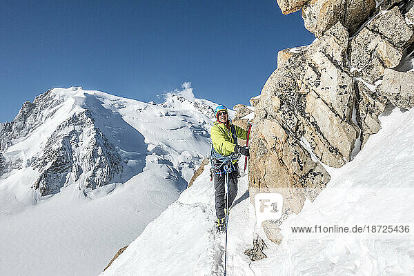 Alpinist navigates a steep snow traverse on the Cosmiques Ridge