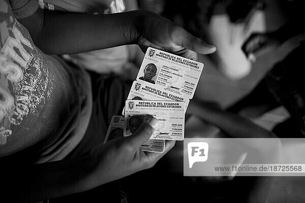 A Colombian refugee child displays his family's new refugee visas in San Mart'n  Ecuador