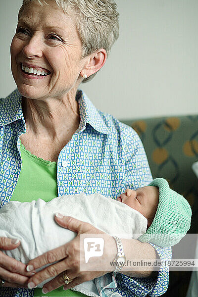 A woman holds a newborn baby girl the day after she was born.