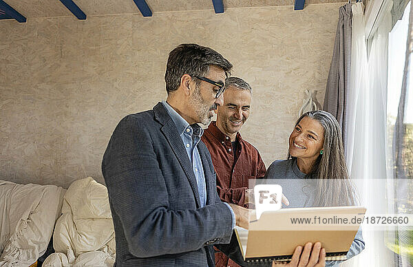 Real estate agent visiting property with new home owners