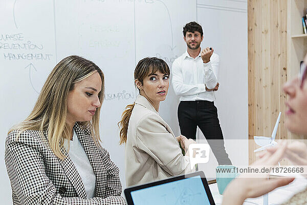 Businesswomen attending a presentation in office