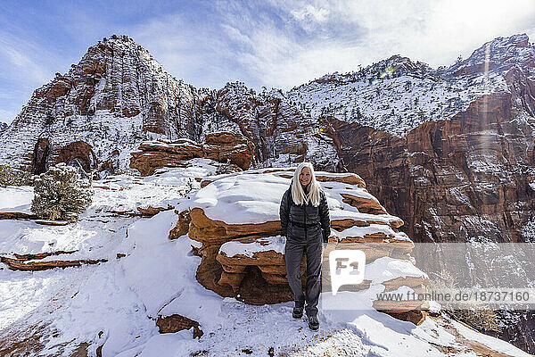 USA  Utah  Springdale  Zion National Park  Senior woman hiking in mountains in winter