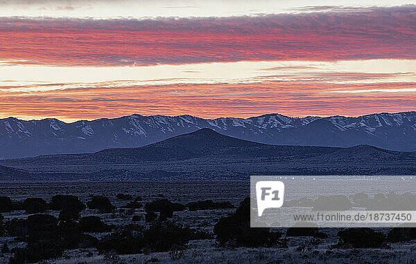 USA  New Mexico  Santa Fe  Dramatic sunset sky over Cerrillos Hills State Park desert landscape