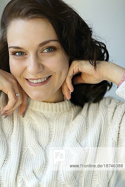 Close Porträt der jungen glücklich zufrieden brunette Mädchen mit geschlossenen Augen berühren saubere frische Haut  die Hände auf ihr Gesicht zeigt frisch gemacht täglichen Make up  genießen neuen Tag zu Hause. Vergnügen Konzept