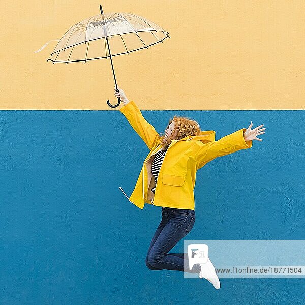Mädchen springt Regenschirm. Foto mit hoher Auflösung