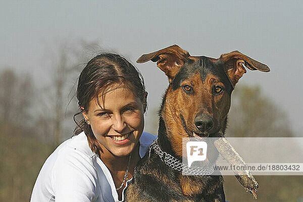 Junge Frau mit Dobermann-Schäferhund Mischling