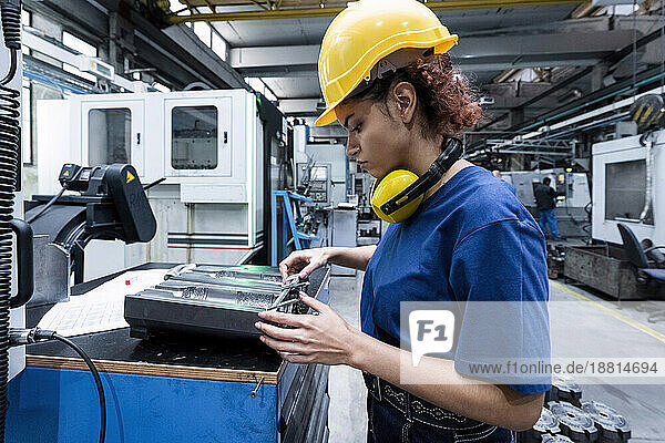 Maintenance engineer working in factory using robotics